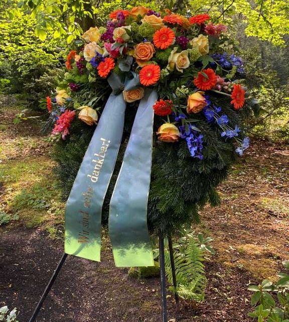 Gärtnerei Vietzen in Ulm | Trauerfloristik Kränze orange Gerbera, gelbe Rosen und blaue Akzente